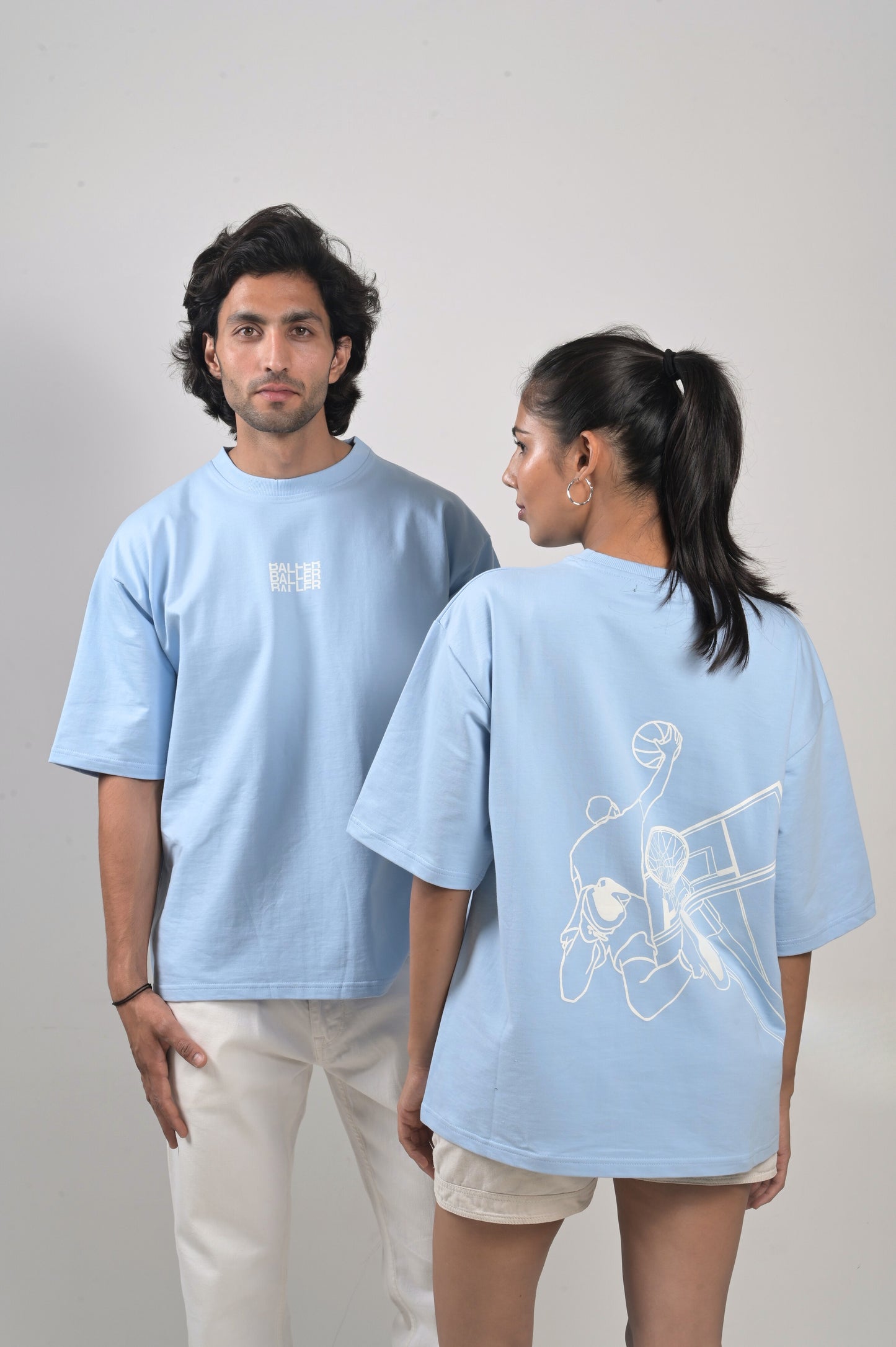 "Unisex oversized white cotton t-shirt with basketball graphic on the back and 'baller' written on the front"